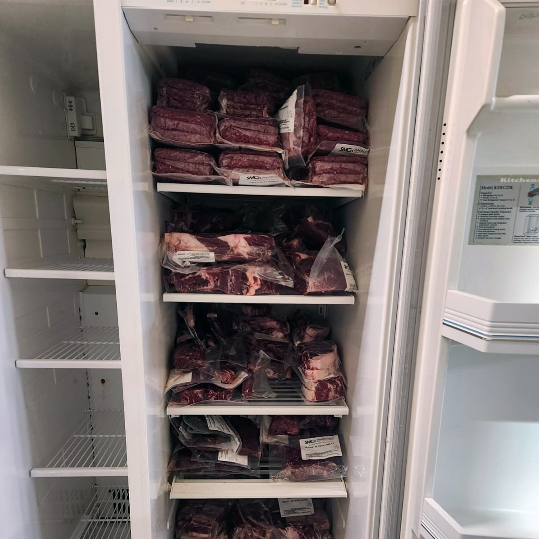 how big of a freezer for a half cow vertical freezer showing packaged beef cuts stored inside