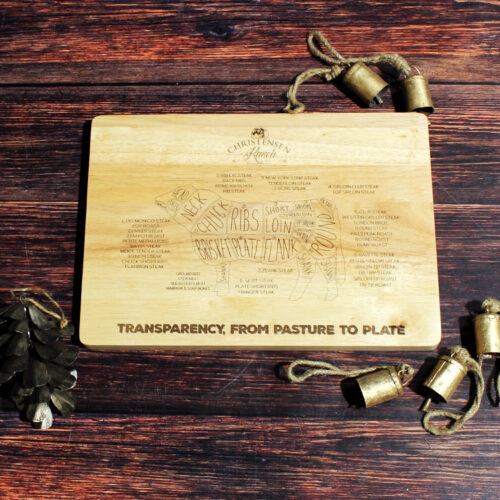 Hand-engraved beef cuts diagram on a light wood cutting board from Christensen Ranch.