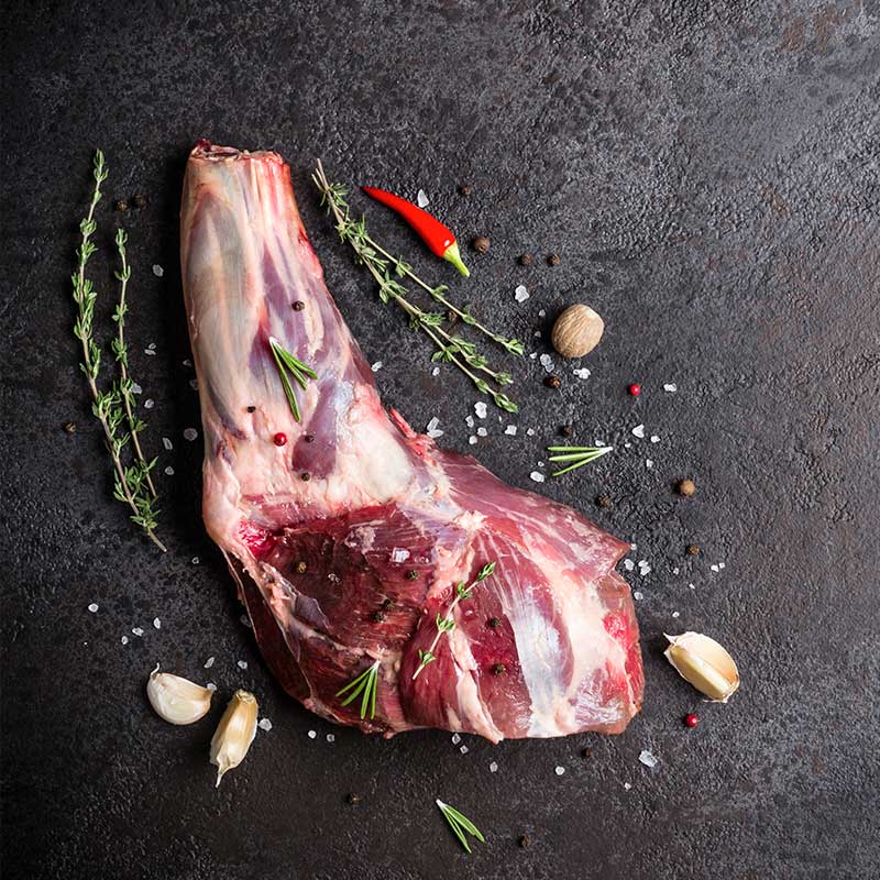 raw whole beef shank with garlic and herbs