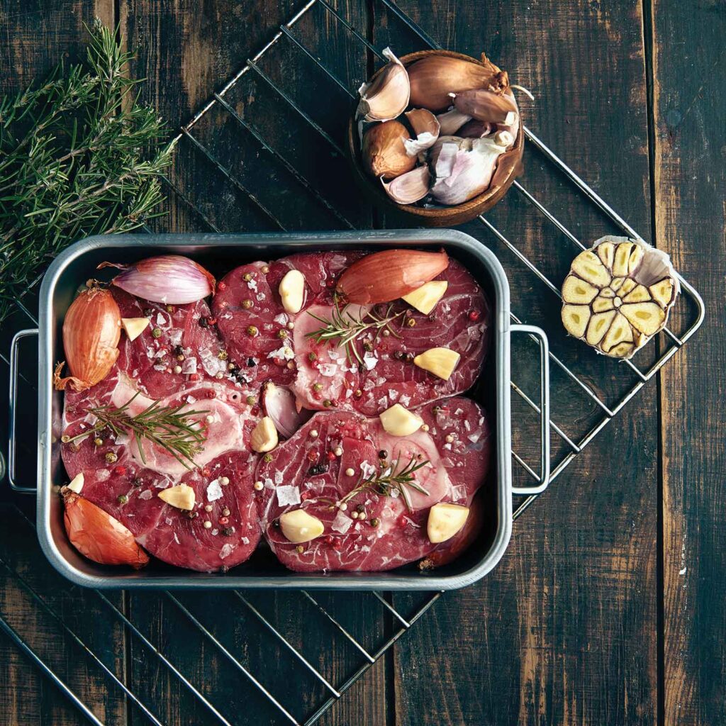 beef in roasting pan with garlic and rosemary