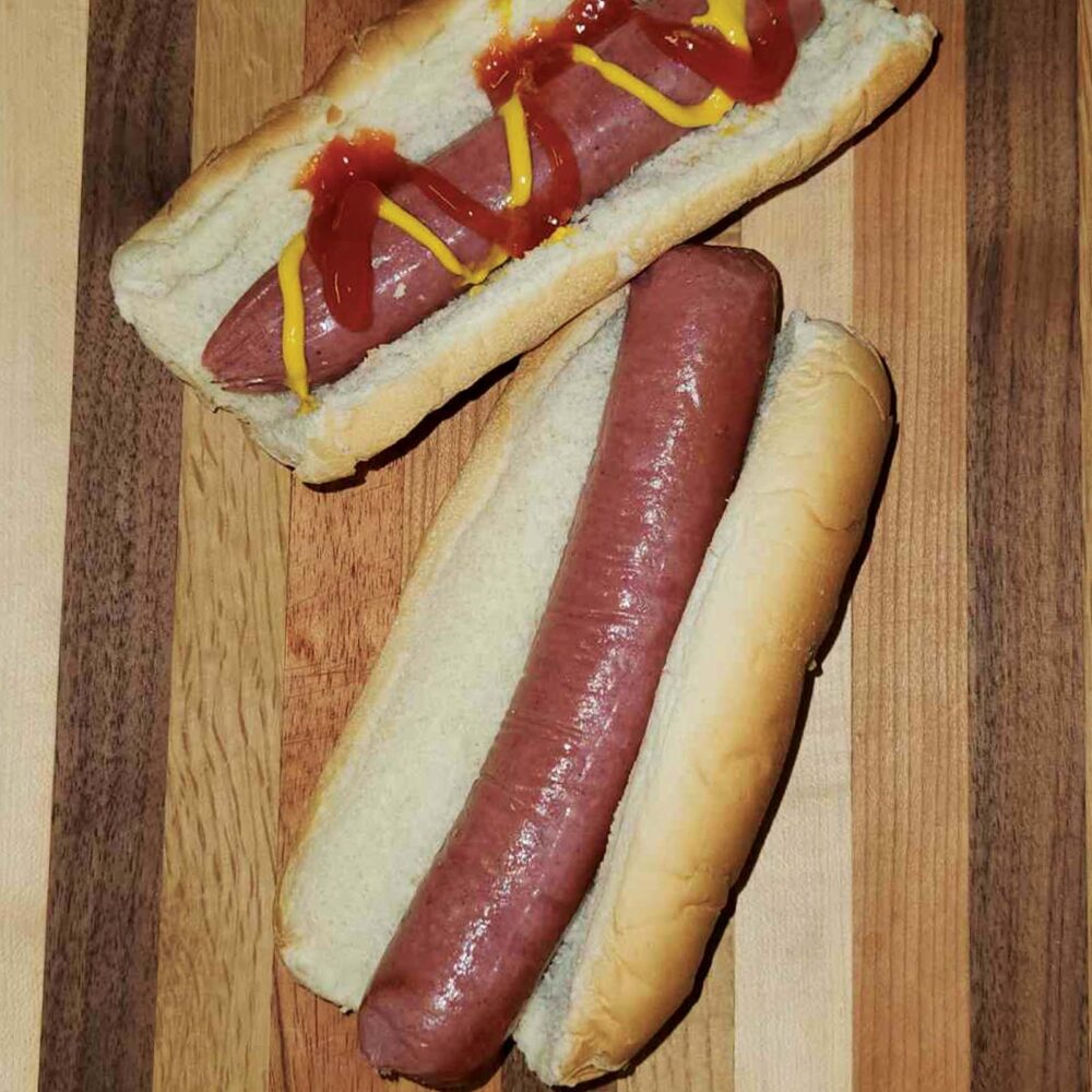 two all beef bun length hot dogs in buns with ketchup and mustard