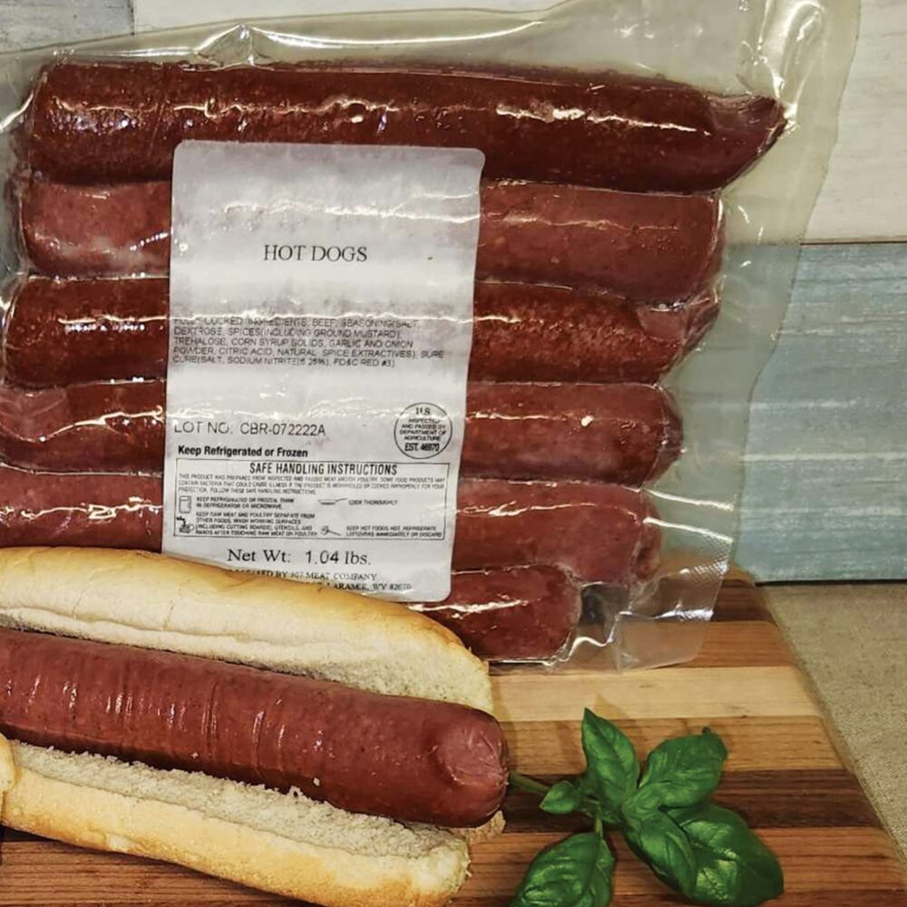 Colorado all beef bun length hot dogs in package with one hot dog in a bun
