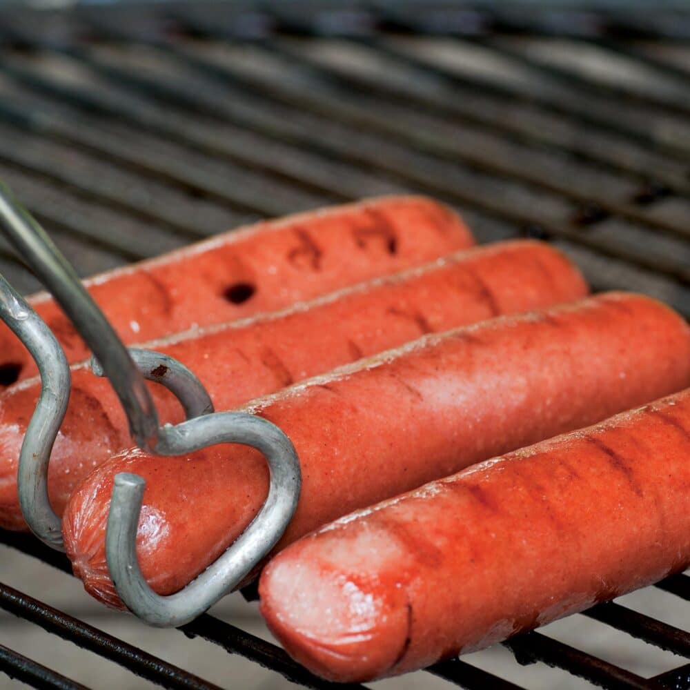All beef hot dogs on grill with grill marks