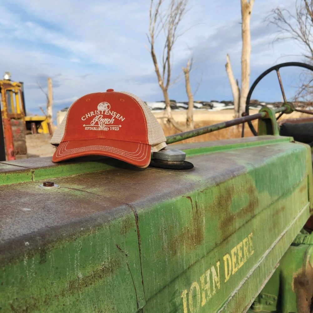 Orange and Khaki Christensen Ranch Washed Trucker Cap with khaki embroidered logo