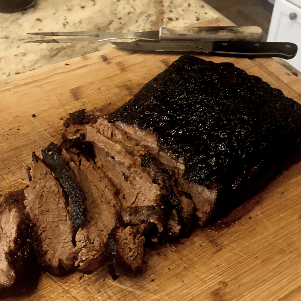Christensen Ranch brisket smoked and sliced on wooden cutting board