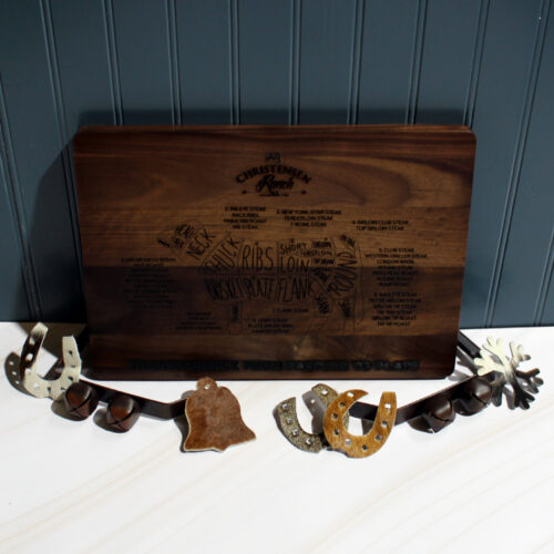 Hand-engraved Christensen Ranch beef cuts diagram on a dark wood cutting board.